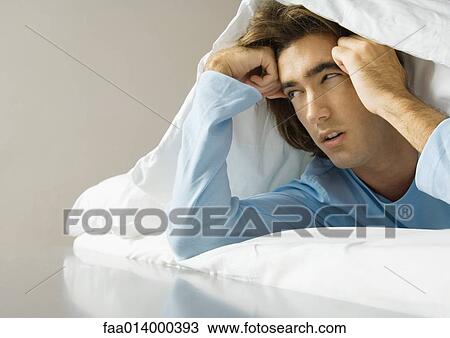 Man lying on stomach, under covers View Large Photo Image Stock Image - Man lying on stomach, under covers. Fotosearch