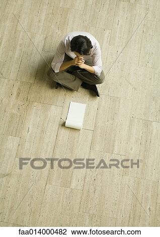 Man sitting on floor with blank pad of paper, high angle view View Large Photo Image Stock Image - Man sitting on floor with blank pad of paper, high angle view. Fotosearch