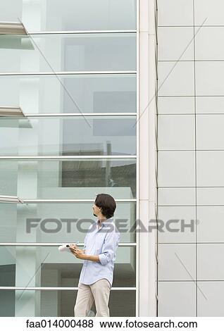 Man standing taking notes on pad of paper View Large Photo Image Stock Photo - Man standing taking notes on pad of paper. Fotosearch