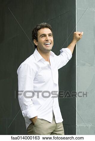 Man standing with hand in pocket, laughing, portrait View Large Photo Image Stock Image - Man standing with hand in pocket, laughing, portrait. Fotosearch