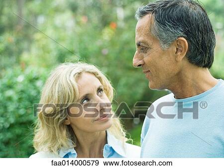 Mature man and woman looking at each other View Large Photo Image Stock Photo - Mature man and woman looking at each other. Fotosearch