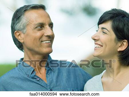 Mid adult woman and mature man smiling View Large Photo Image Picture - Mid adult woman and mature man smiling. Fotosearch
