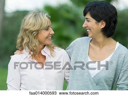 Mid adult woman and mature woman smiling at each other View Large Photo Image Stock Image - Mid adult woman and mature woman smiling at each other. Fotosearch