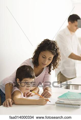 Mother helping child with homework View Large Photo Image Picture - Mother helping child with homework. Fotosearch