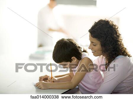 Stock Photo - Mother helping child with homework. Fotosearch