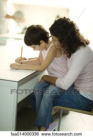 Stock Photograph - Mother helping child with homework. Fotosearch