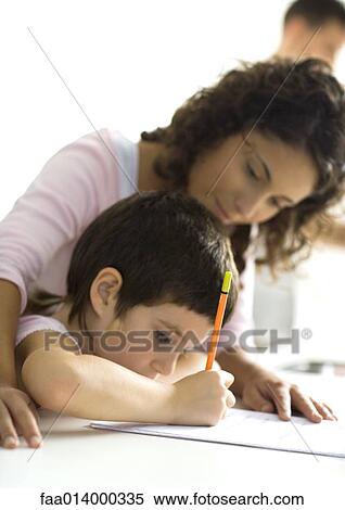 Stock Photography - Mother helping child with homework. Fotosearch