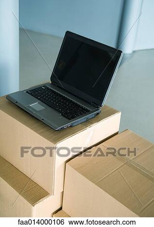Open laptop on stack of cardboard boxes View Large Photo Image Stock Photograph - Open laptop on stack of cardboard boxes. Fotosearch