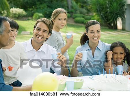 Outdoor birthday party attended by multi-generational family View Large Photo Image Stock Image - Outdoor birthday party attended by multi-generational family. Fotosearch