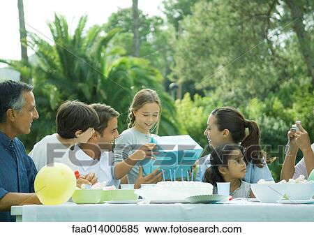 Outdoor birthday party, girl receiving present View Large Photo Image Stock Photography - Outdoor birthday party, girl receiving present. Fotosearch