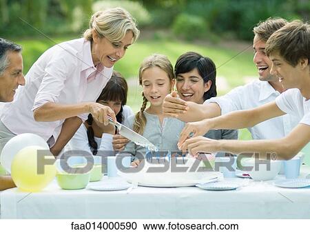 Outdoor birthday party, mature woman cutting birthday cake View Large Photo Image Stock Image - Outdoor birthday party, mature woman cutting birthday cake. Fotosearch