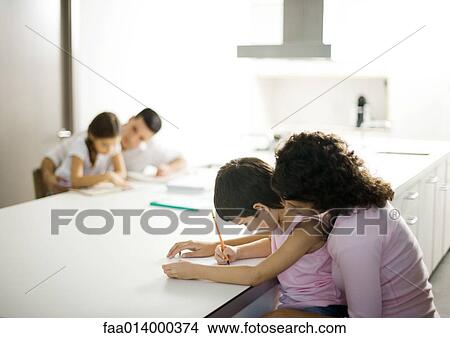 Picture - Parents helping their children with homework. Fotosearch