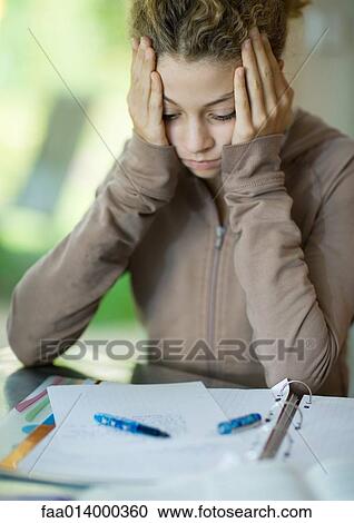 Preteen girl doing homework, holding head View Large Photo Image Stock Image - Preteen girl doing homework, holding head. Fotosearch