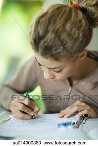 Preteen girl doing homework View Large Photo Image Stock Image - Preteen girl doing homework. Fotosearch