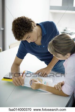 Teenage boy and girl doing homework together View Large Photo Image Stock Image - Teenage boy and girl doing homework together. Fotosearch