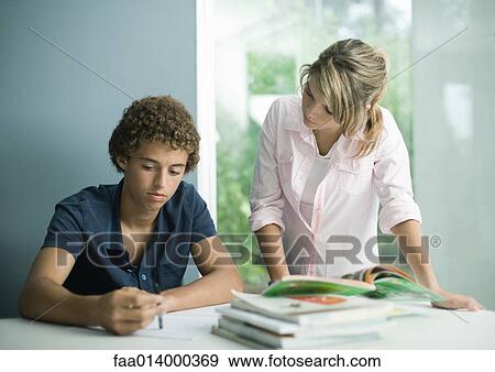 Teenage boy and girl doing homework together View Large Photo Image Stock Photo - Teenage boy and girl doing homework together. Fotosearch