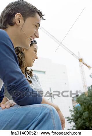 Teenage boy and girl outdoors, low angle view View Large Photo Image Stock Photo - Teenage boy and girl outdoors, low angle view. Fotosearch