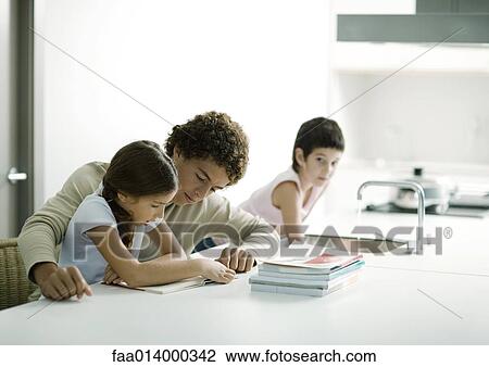 Teenage boy helping younger sister with homework View Large Photo Image Stock Image - Teenage boy helping younger sister with homework. Fotosearch