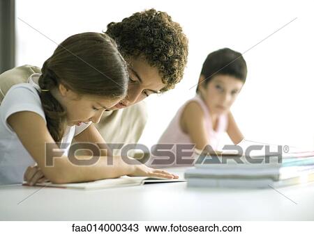 Teenage boy helping younger sister with homework View Large Photo Image Stock Image - Teenage boy helping younger sister with homework. Fotosearch