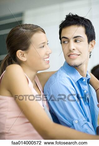 Teenage couple, smiling at each other View Large Photo Image Stock Image - Teenage couple, smiling at each other. Fotosearch