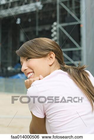 Teenage girl looking over shoulder View Large Photo Image Stock Photograph - Teenage girl looking over shoulder. Fotosearch