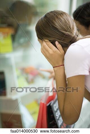 Teenage girls looking into shop window View Large Photo Image Stock Image - Teenage girls looking into shop window. Fotosearch