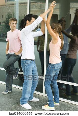 Teenagers hanging out, two dancing while friend watches View Large Photo Image Stock Photography - Teenagers hanging out, two dancing while friend watches. Fotosearch