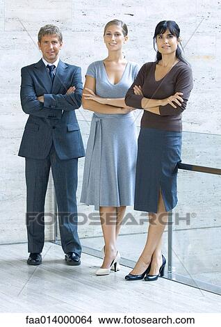 Three business executives standing with arms folded, full length portrait View Large Photo Image Picture - Three business executives standing with arms folded, full length portrait. Fotosearch