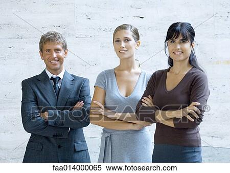 Three business executives standing with arms folded, portrait View Large Photo Image Stock Photography - Three business executives standing with arms folded, portrait. Fotosearch