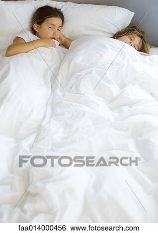 Stock Photograph - Two children sleeping in bed. Fotosearch