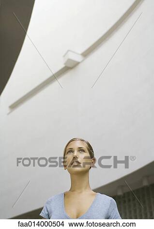 Picture - Woman, head and shoulders, low angle view. Fotosearch