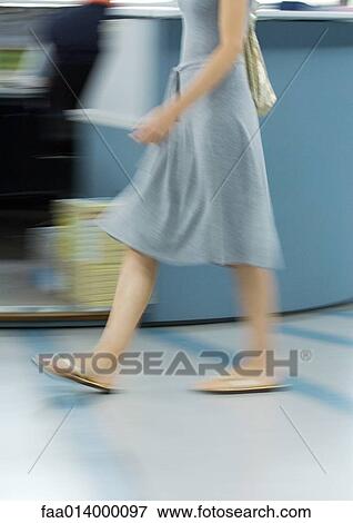 Woman in dress and flipflops walking, chest down, blurred motion View Large Photo Image Stock Photo - Woman in dress and flipflops walking, chest down, blurred motion. Fotosearch
