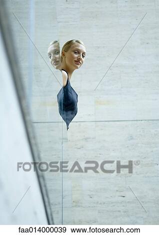 Woman looking over glass guard rail, low angle view View Large Photo Image Stock Photo - Woman looking over glass guard rail, low angle view. Fotosearch