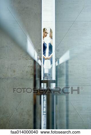 Woman seen through narrow opening in mid distance View Large Photo Image Stock Image - Woman seen through narrow opening in mid distance. Fotosearch