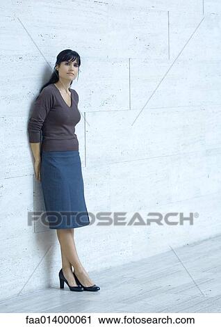 Woman standing, leaning against wall, portrait View Large Photo Image Stock Image - Woman standing, leaning against wall, portrait. Fotosearch