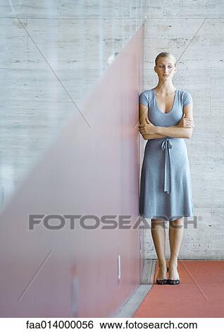 Woman standing, leaning against wall, full length portrait View Large Photo Image Stock Photograph - Woman standing, leaning against wall, full length portrait. Fotosearch