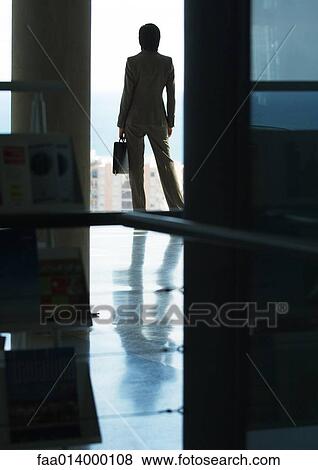 Woman standing with briefcase, looking out bay window, in silhouette View Large Photo Image Stock Photo - Woman standing with briefcase, looking out bay window, in silhouette. Fotosearch