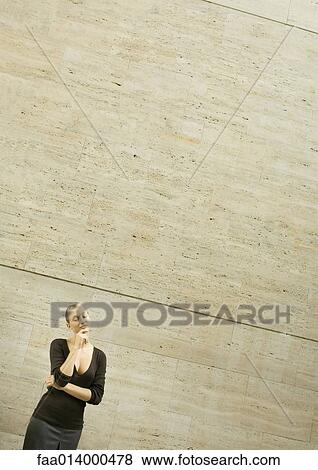 Woman standing with eyes closed and hand under chin View Large Photo Image Stock Photo - Woman standing with eyes closed and hand under chin. Fotosearch