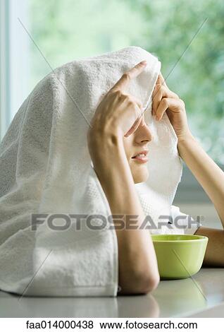 Woman with face over bowl and towel over head View Large Photo Image Stock Photo - Woman with face over bowl and towel over head. Fotosearch