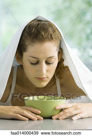 Woman with face over bowl and towel over head View Large Photo Image Stock Photo - Woman with face over bowl and towel over head. Fotosearch