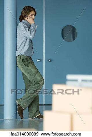Young man using cell phone View Large Photo Image Stock Photo - Young man using cell phone. Fotosearch