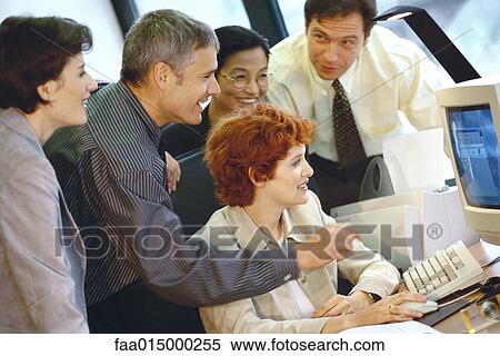 Business associates grouped around computer View Large Photo Image Stock Photography - Business associates grouped around computer. Fotosearch