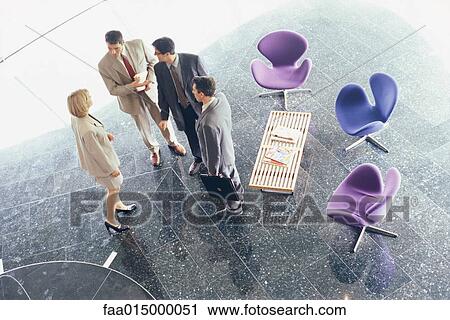 Business associates standing in lobby, high angle view View Large Photo Image Stock Image - Business associates standing in lobby, high angle view. Fotosearch