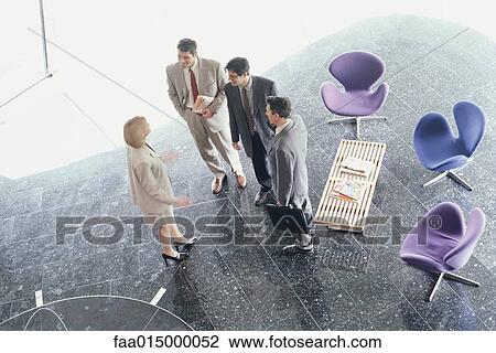 Business associates standing in lobby, high angle view View Large Photo Image Stock Image - Business associates standing in lobby, high angle view. Fotosearch