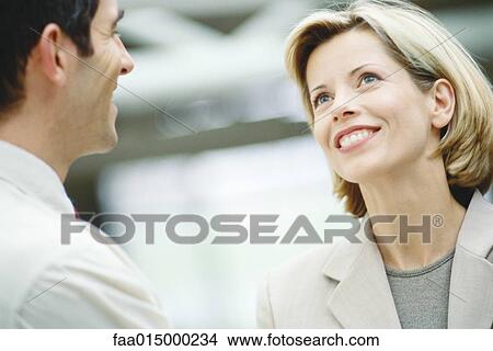 Business associates talking, close-up View Large Photo Image Picture - Business associates talking, close-up. Fotosearch