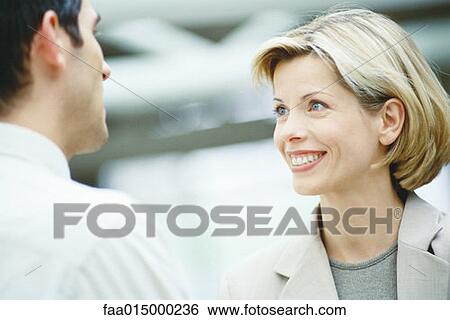 Business associates talking, close-up View Large Photo Image Stock Photograph - Business associates talking, close-up. Fotosearch