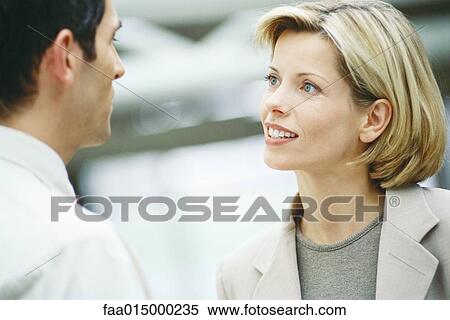 Business associates talking, close-up View Large Photo Image Stock Photography - Business associates talking, close-up. Fotosearch