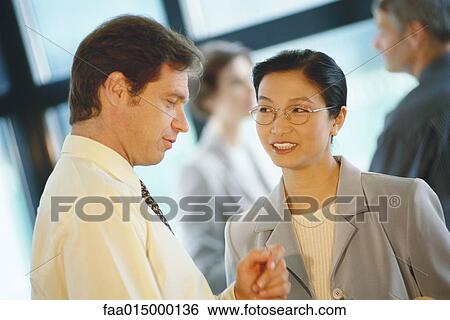Stock Photograph - Business associates talking. Fotosearch