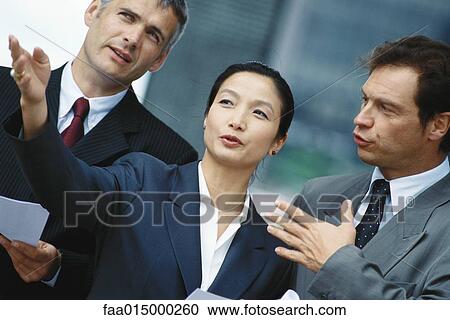 Business associates, woman in foreground gesturing View Large Photo Image Stock Image - Business associates, woman in foreground gesturing. Fotosearch