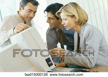 Business associates working at desktop computer View Large Photo Image Stock Photograph - Business associates working at desktop computer. Fotosearch